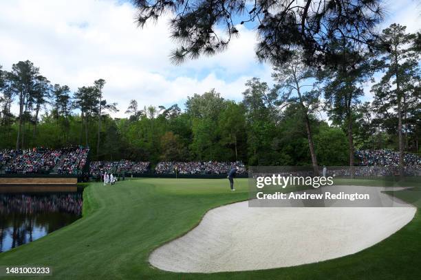 Jon Rahm of Spain putts on the 15th green during the continuation of the weather delayed third round of the 2023 Masters Tournament at Augusta...