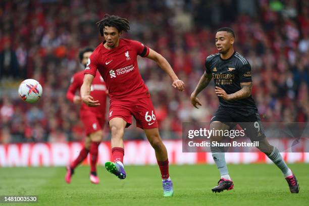 Trent Alexander-Arnold of Liverpool passes the ball whilst under pressure from Gabriel Jesus of Arsenal during the Premier League match between...