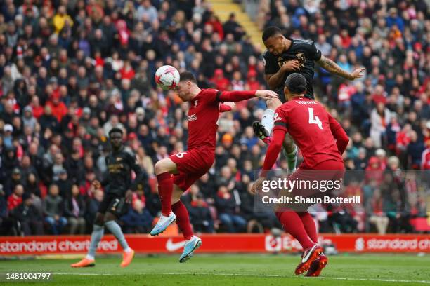 Gabriel Jesus of Arsenal scores the team's second goal whilst under pressure from Andrew Robertson of Liverpool during the Premier League match...