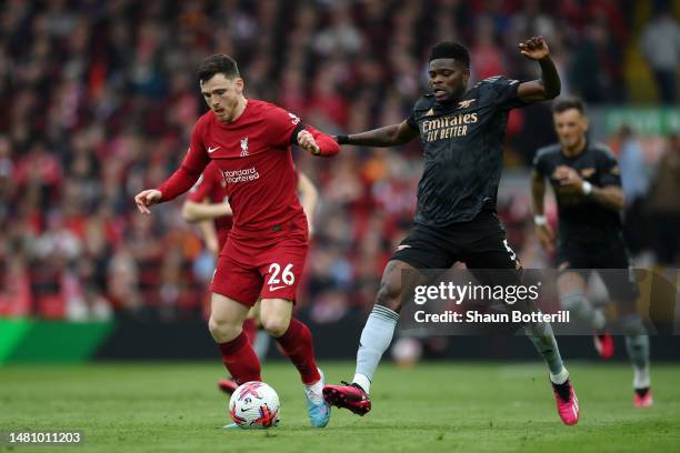Andrew Robertson of Liverpool runs with the ball whilst under pressure from Thomas Partey of Arsenal during the Premier League match between...