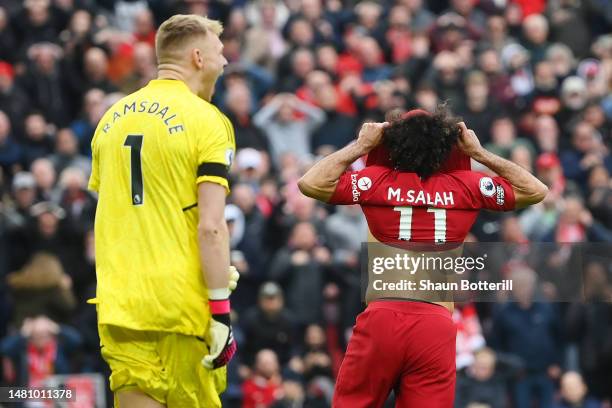Mohamed Salah of Liverpool reacts after missing a penalty kick as Aaron Ramsdale of Arsenal looks on during the Premier League match between...