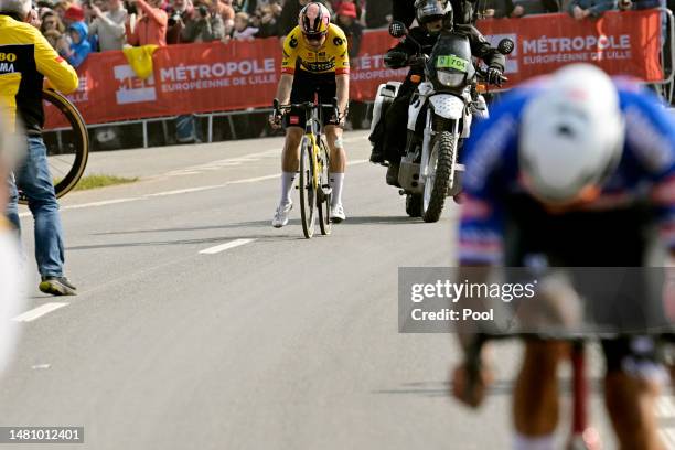 Wout Van Aert of Belgium and Team Jumbo-Visma with a flat tire looks for assistance in the final part of the race during the 120th Paris-Roubaix...