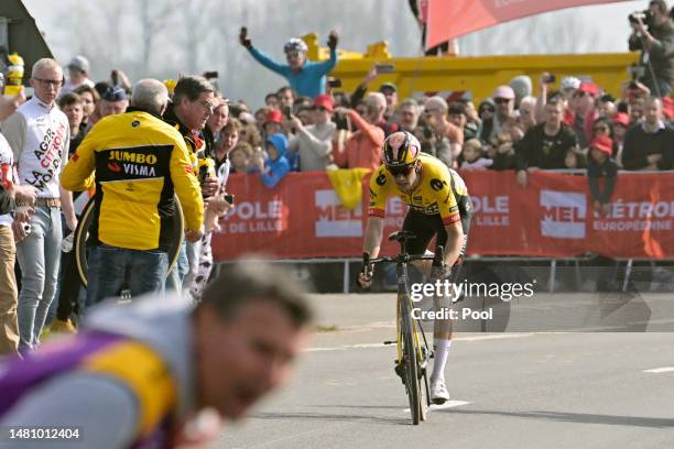 Wout Van Aert of Belgium and Team Jumbo-Visma with a flat tire looks for assistance in the final part of the race during the 120th Paris-Roubaix...