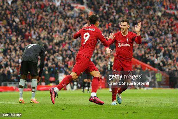 Roberto Firmino of Liverpool celebrates after scoring the team's second goal with teammate Andrew Robertson during the Premier League match between...