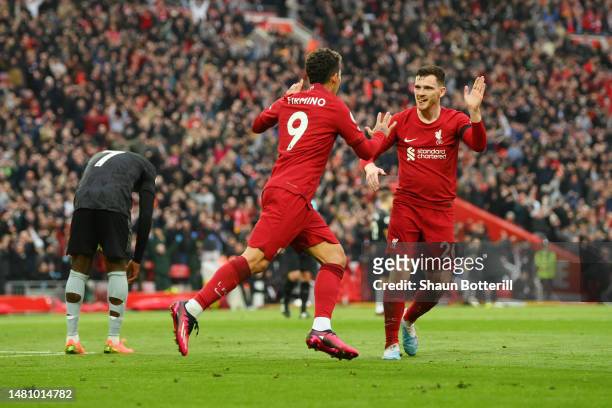 Roberto Firmino of Liverpool celebrates after scoring the team's second goal with teammate Andrew Robertson during the Premier League match between...