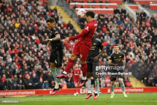 Roberto Firmino of Liverpool scores the team's second goal whilst under pressure from Ben White of Arsenal during the Premier League match between...