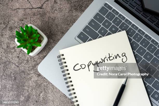 copy writing text on notepad with laptop - copy writing stock-fotos und bilder