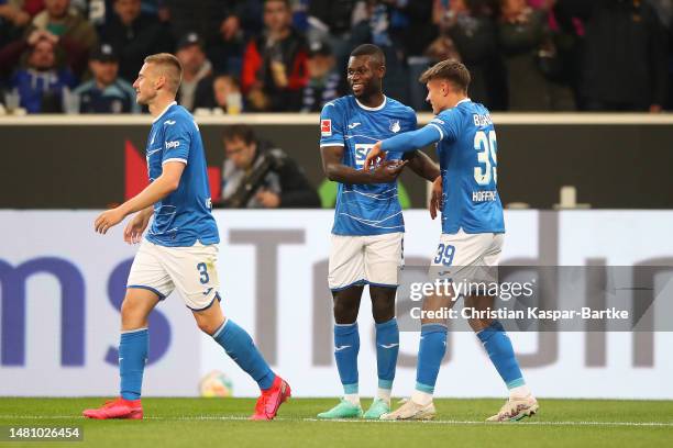 Ihlas Bebou of TSG Hoffenheim celebrates after scoring the team's second goal from a penalty kick with teammates during the Bundesliga match between...