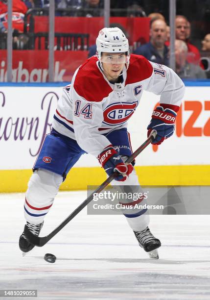 Nick Suzuki of the Montreal Canadiens skates with the puck against the Toronto Maple Leafs during an NHL game at Scotiabank Arena on April 8, 2023 in...