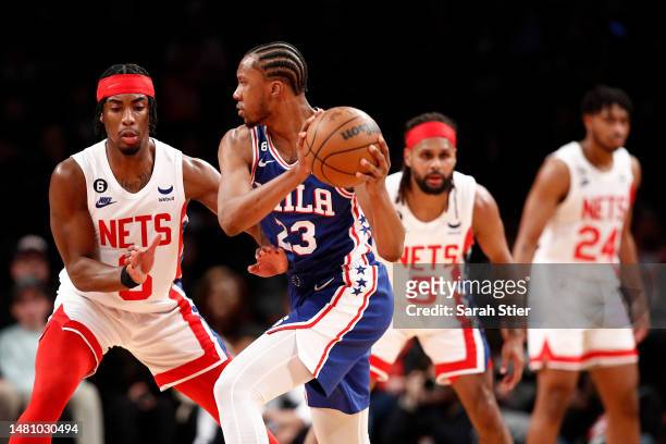 Louis King of the Philadelphia 76ers looks to pass as David Duke Jr. #6 of the Brooklyn Nets defends during the first half at Barclays Center on...