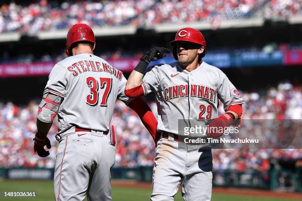 Tyler Stephenson and TJ Friedl of the Cincinnati Reds react following a run scored by Friedl during the ninth inning against the Philadelphia...