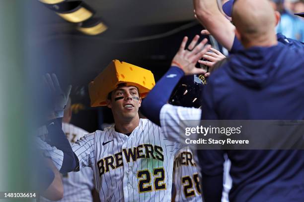 Christian Yelich of the Milwaukee Brewers is congratulated by teammates following a home run against the St. Louis Cardinals during the seventh...