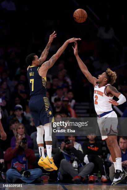 George Hill of the Indiana Pacers shoots a three point shot as Miles McBride of the New York Knicks defends at Madison Square Garden on April 09,...