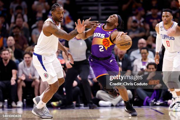 Kawhi Leonard of the Los Angeles Clippers fouls Josh Okogie of the Phoenix Suns during the first half of the game at Footprint Center on April 09,...