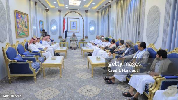 Handout photo released by Yemen's Houthis-run Saba News Agency shows the Omani and Saudi delegations in meeting Houthi officials, on April 09, 2023...