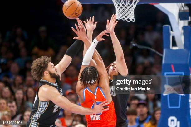 David Roddy and Kenneth Lofton Jr. #6 of the Memphis Grizzlies defend Ousmane Dieng of the Oklahoma City Thunder during the second quarter at Paycom...