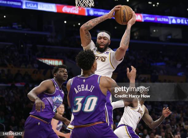 Anthony Davis of the Los Angeles Lakers grabs a rebound in front of Ochai Agbaji and Udoka Azubuike of the Utah Jazz during the first half at...