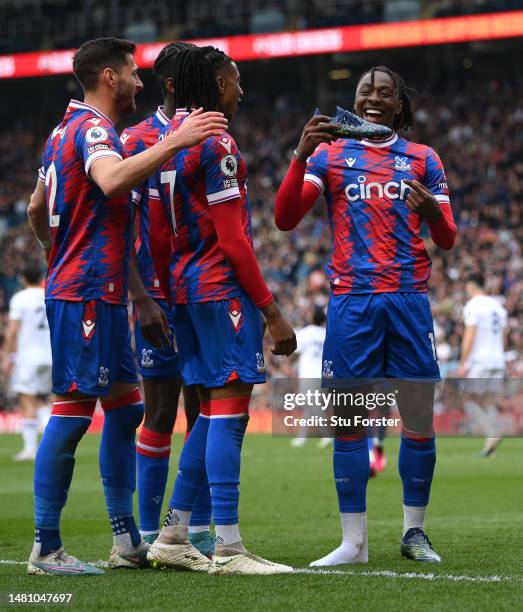 Crystal Palace player Eberechi Eze shows off his new balance boot as he celebrates with team mates after scoring the third Palace goal during the...