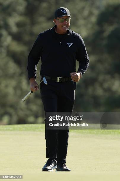 Phil Mickelson of the United States reacts to his birdie putt on the 18th green during the final round of the 2023 Masters Tournament at Augusta...