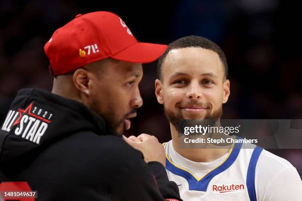 Damian Lillard of the Portland Trail Blazers and Stephen Curry of the Golden State Warriors greet one another during the fourth quarter at Moda...