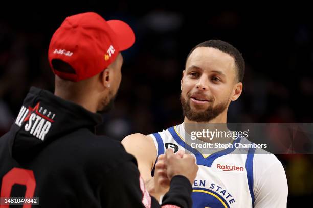 Damian Lillard of the Portland Trail Blazers and Stephen Curry of the Golden State Warriors greet one another during the fourth quarter at Moda...