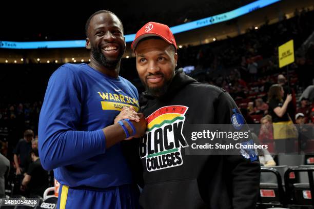 Draymond Green of the Golden State Warriors and Damian Lillard of the Portland Trail Blazers greet each other before the game at Moda Center on April...