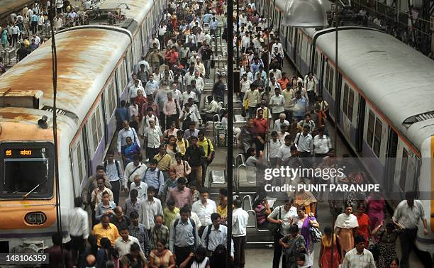 Indian commuters walk on the Churchgate station railway platform on the eve of World population Day, in Mumbai July 10, 2012. Africa and Asia are the...
