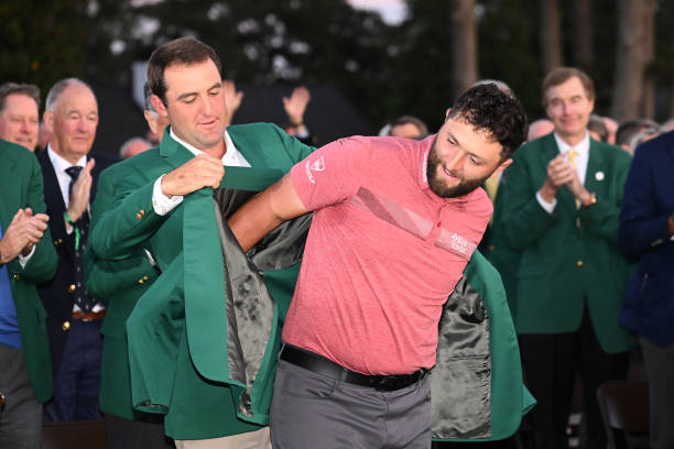 Scottie Scheffler of the United States puts the green jacket on Jon Rahm of Spain after he won the 2023 Masters Tournament at Augusta National Golf...