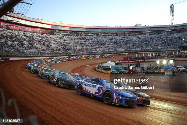 Kyle Larson, driver of the HendrickCars.com Chevrolet, leads the field during the NASCAR Cup Series Food City Dirt Race at Bristol Motor Speedway on...