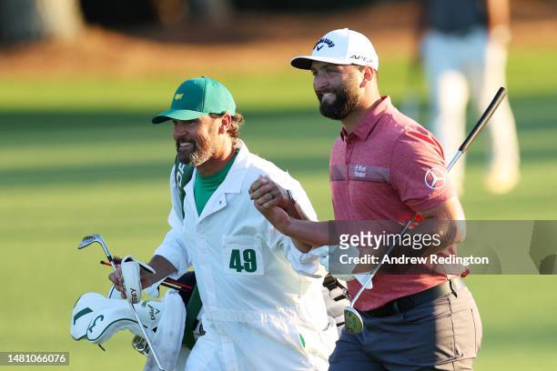 Jon Rahm of Spain and his caddie Adam Hayes react as they approach the 18th green at Augusta National Golf Club on April 09, 2023 in Augusta, Georgia.