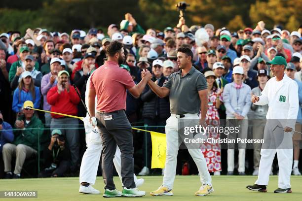 Jon Rahm of Spain shakes hands with Brooks Koepka of the United States on the 18th green after he won the 2023 Masters Tournament at Augusta National...