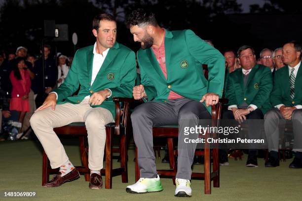 Masters Champion Scottie Scheffler of the United States looks on with Jon Rahm of Spain during the Green Jacket Ceremony after Rahm won the 2023...