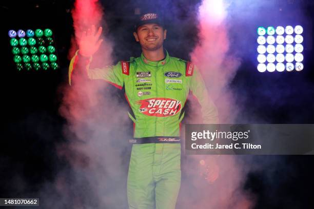 Todd Gilliland, driver of the Speedy Cash Ford, walks onstage during driver intros prior to the NASCAR Cup Series Food City Dirt Race at Bristol...