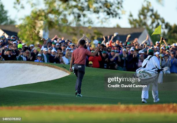 Jon Rahm of Spain walk onto the 18th green with his caddie Adam Hayes during the final round of the 2023 Masters Tournament at Augusta National Golf...