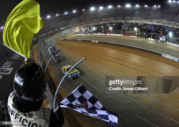 Christopher Bell, driver of the DeWalt Power Stack Toyota, takes the checkered flag under caution to win the NASCAR Cup Series Food City Dirt Race at...