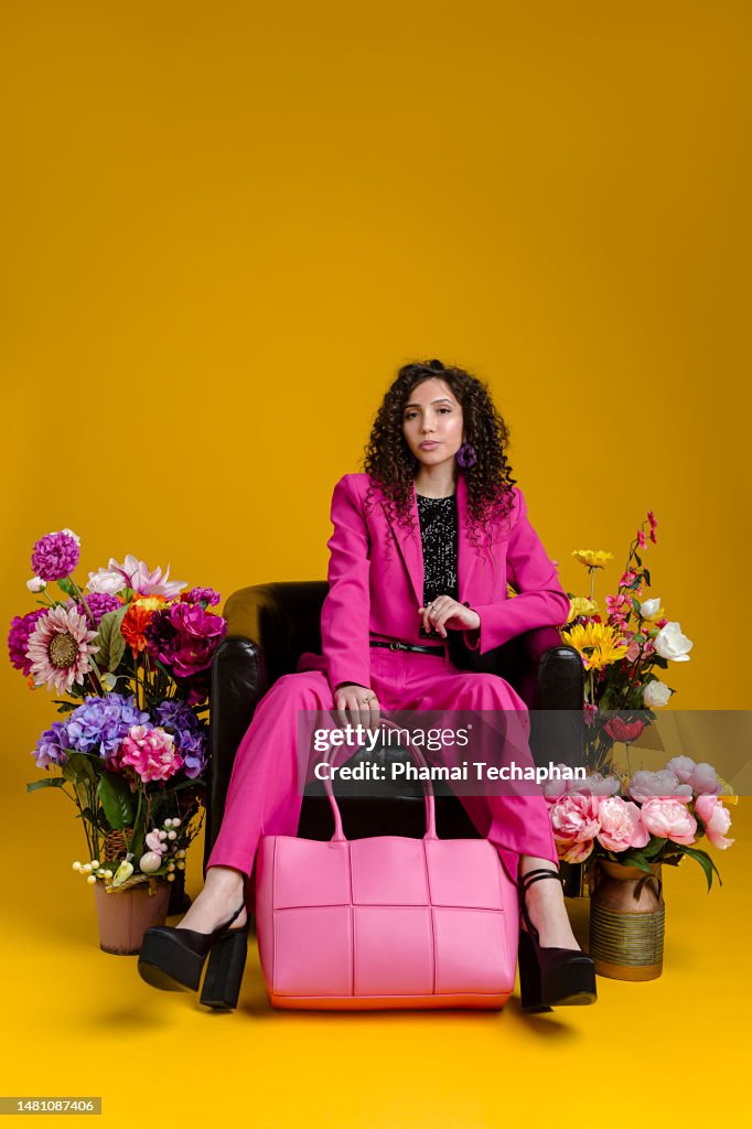 Beautiful woman sitting among flowers