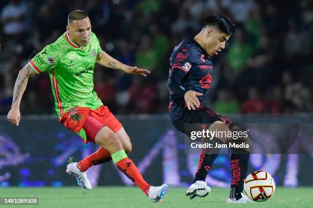 Jesus Duenas of Juarez fights for the ball with Aldo Rocha of Atlas during the 14th round match between SFC Juarez and Atlas as part of the Torneo...