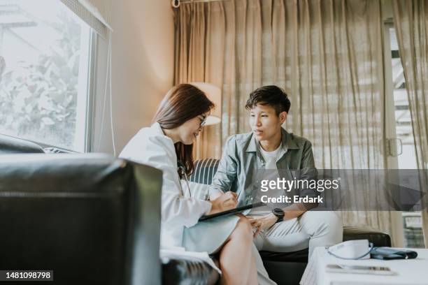 appointment with doctor to update and follow up body after got a gender affirmation surgery last month. - southeast asian ethnicity stock pictures, royalty-free photos & images