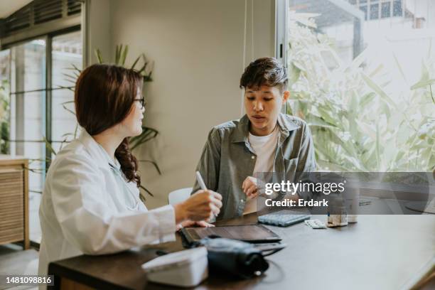transgender man consulting with psychiatrist before getting gender affirmation surgery. - female to male surgery stockfoto's en -beelden