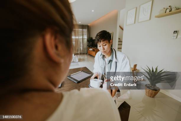 asian transgender man as a nutritionist giving advice to plus size patient. - southeast asian ethnicity stock pictures, royalty-free photos & images