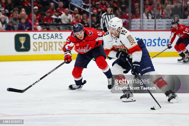 Matthew Tkachuk of the Florida Panthers skates with the puck as Martin Fehervary of the Washington Capitals defends during the first period of the...
