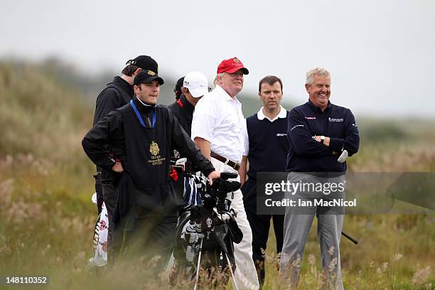 Donald Trump and Colin Montgomerie share a joke after the opening of The Trump International Golf Links Course on July 10, 2012 in Balmedie,...