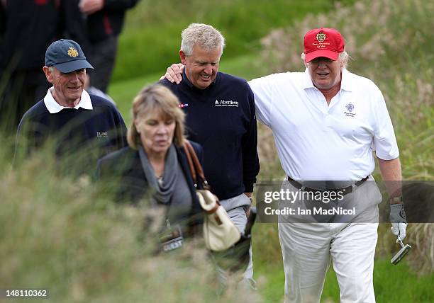 Donald Trump and Colin Montgomerie share a joke after the opening of The Trump International Golf Links Course on July 10, 2012 in Balmedie,...
