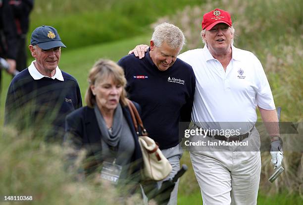 Donald Trump and Colin Montgomerie share a joke after the opening of The Trump International Golf Links Course on July 10, 2012 in Balmedie,...