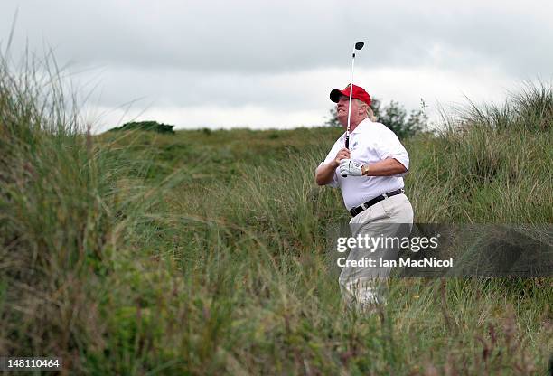 Donald Trump plays a round of golf after the opening of The Trump International Golf Links Course on July 10, 2012 in Balmedie, Scotland. The...