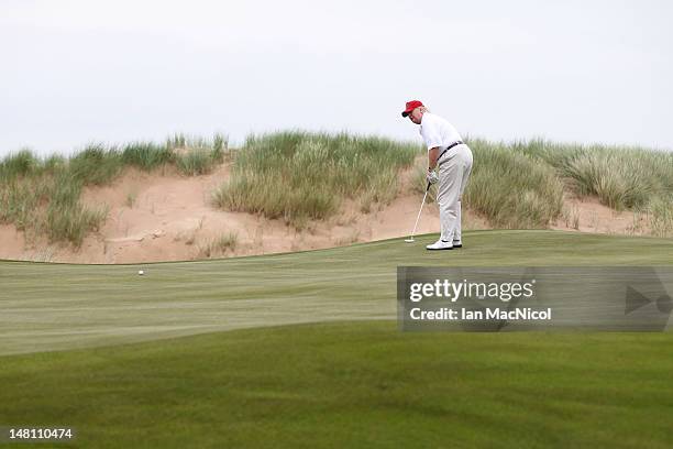 Donald Trump plays a round of golf after the opening of The Trump International Golf Links Course on July 10, 2012 in Balmedie, Scotland. The...