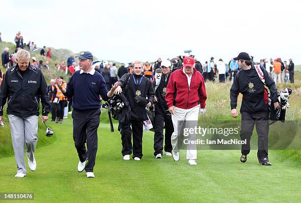 Donald Trump is accompanied by the media during the opening of The Trump International Golf Links Course on July 10, 2012 in Balmedie, Scotland. The...