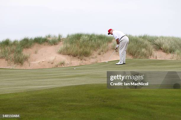 Donald Trump plays a round of golf after the opening of The Trump International Golf Links Course on July 10, 2012 in Balmedie, Scotland. The...