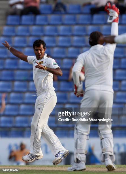 Nuwan Kulasekara of Sri Lanka celebrates with team-mate Prasanna Jayawardene after dismIssing Pakistan batsman Taufeeq Umar during day three of the...