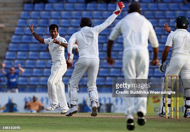 Nuwan Kulasekara of Sri Lanka celebrates with team-mate Prasanna Jayawardene after dismissing Pakistan batsman Taufeeq Umar during day three of the...